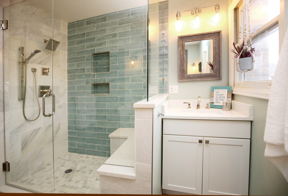 This is an example of a small beach style master bathroom in Denver with raised-panel cabinets, white cabinets, a corner shower, blue tile, ceramic tile, green walls, porcelain floors, an undermount sink, brown floor, a hinged shower door, white benchtops, a double vanity and a built-in vanity.
