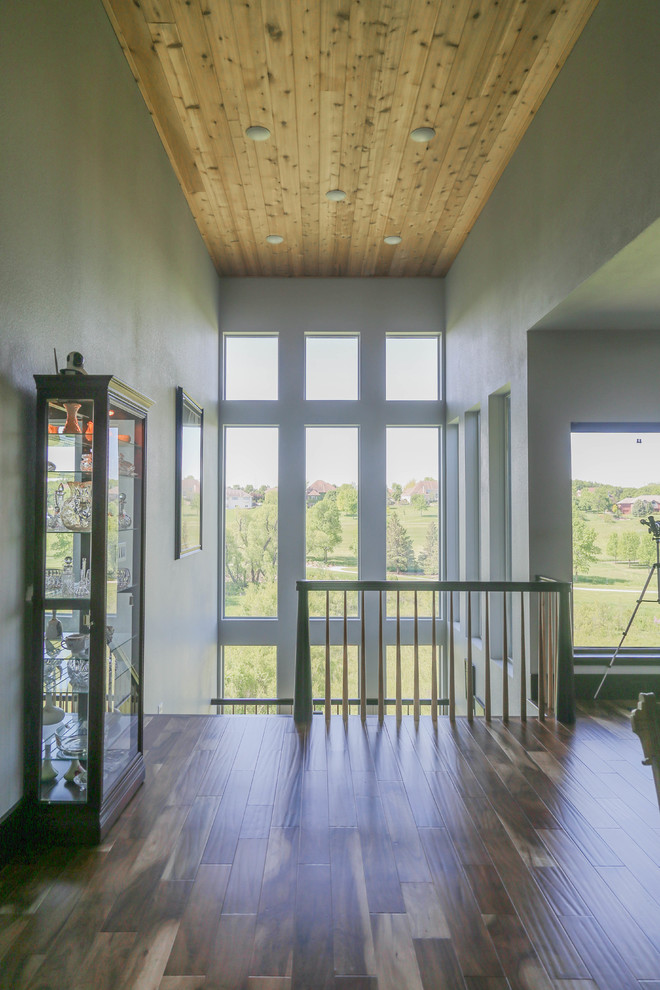 Inspiration for a large transitional wooden u-shaped wood railing home design remodel with wooden risers