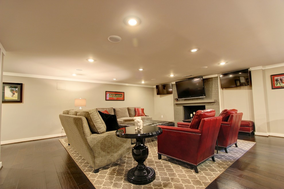 Photo of a large contemporary walk-out basement in Atlanta with beige walls, a standard fireplace, a brick fireplace surround and medium hardwood floors.