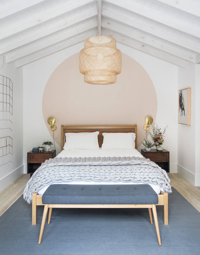 Scandinavian bedroom in New York with multi-coloured walls and light hardwood floors.
