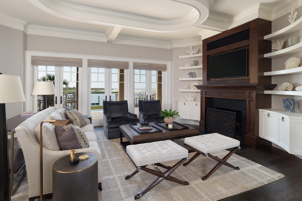 Photo of a medium sized traditional living room in Charleston with grey walls, dark hardwood flooring, a standard fireplace, a wooden fireplace surround, a built-in media unit, brown floors and a coffered ceiling.
