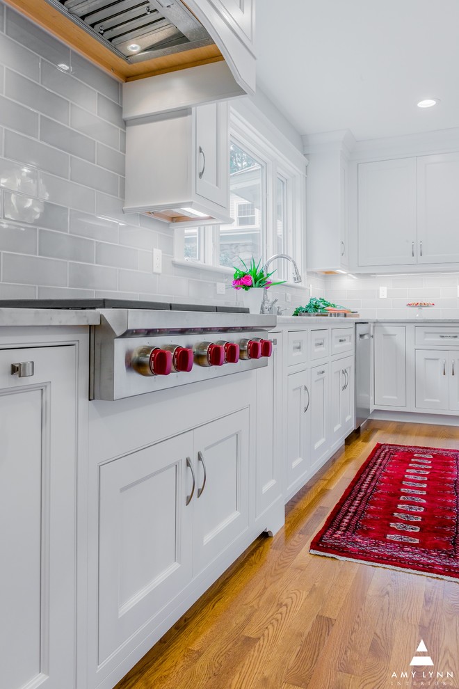 Example of a mid-sized transitional l-shaped medium tone wood floor and red floor eat-in kitchen design in Boston with an undermount sink, beaded inset cabinets, white cabinets, marble countertops, gray backsplash, porcelain backsplash, paneled appliances, an island and yellow countertops