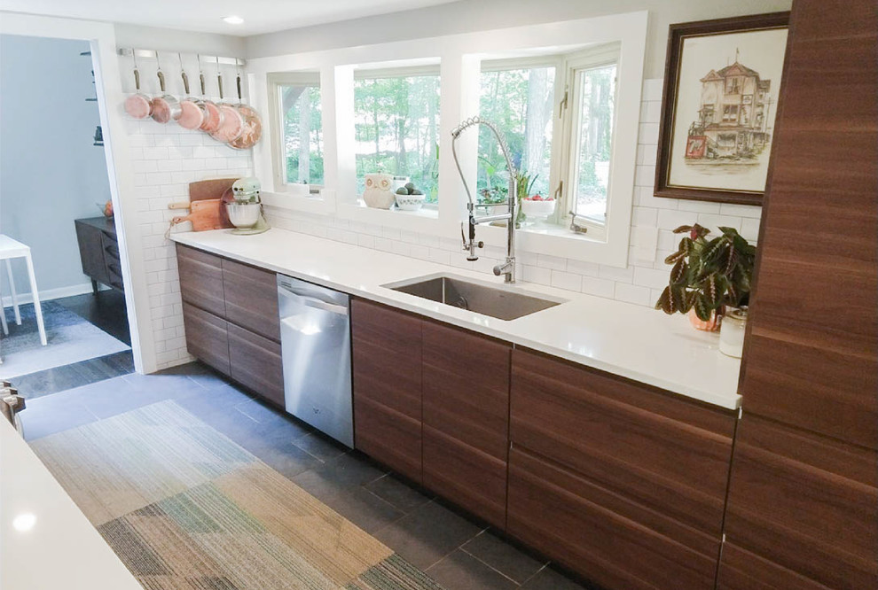 Inspiration for a small midcentury galley eat-in kitchen in Other with an undermount sink, flat-panel cabinets, brown cabinets, quartzite benchtops, white splashback, subway tile splashback, stainless steel appliances, cement tiles, no island, grey floor and white benchtop.