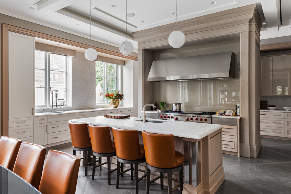 Inspiration for a large transitional u-shaped eat-in kitchen in Toronto with an undermount sink, beige cabinets, grey splashback, glass sheet splashback, stainless steel appliances, with island, grey floor and white benchtop.