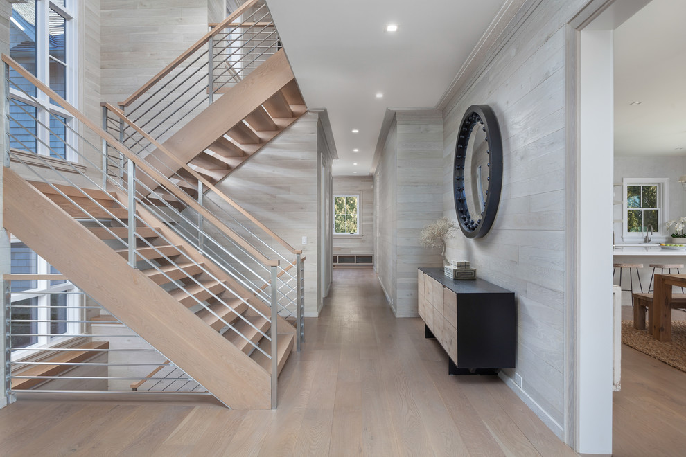 Photo of a country wood u-shaped staircase in New York with open risers and mixed railing.