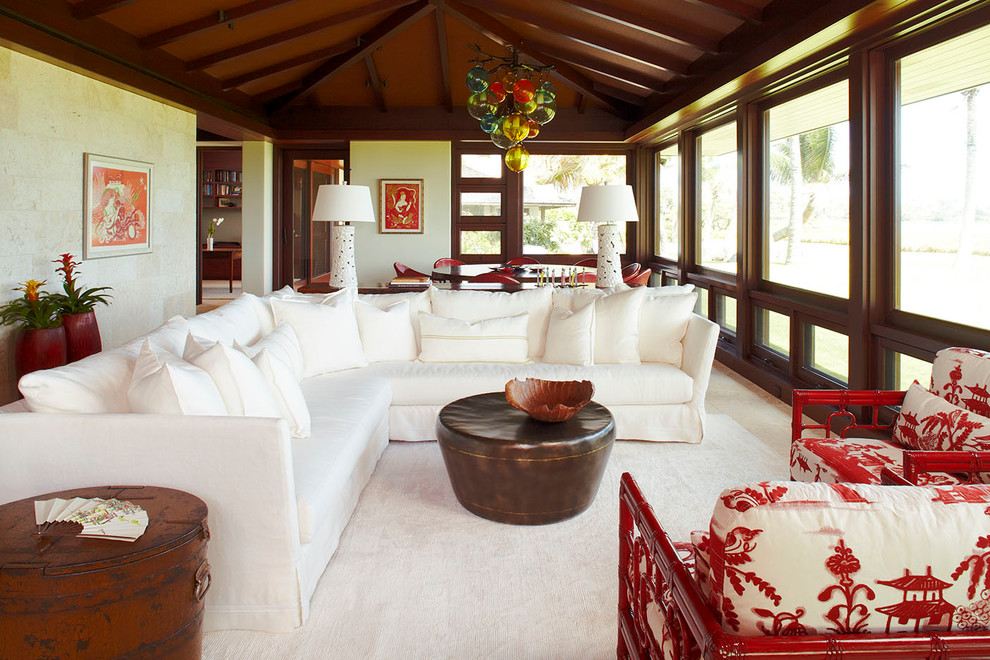 Inspiration for a tropical living room in Hawaii with beige walls and carpet.
