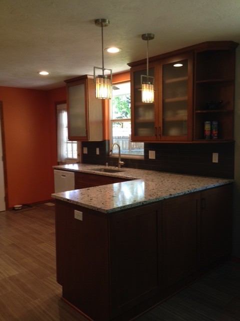 Example of a transitional porcelain tile kitchen design in Seattle with an undermount sink, shaker cabinets, medium tone wood cabinets, quartz countertops, gray backsplash, glass tile backsplash and white appliances