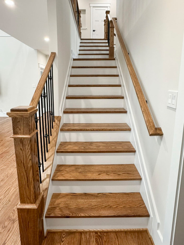 Photo of a mid-sized transitional wood curved staircase in DC Metro with wood risers and mixed railing.