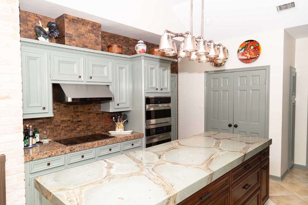 Large country u-shaped kitchen pantry in Houston with a farmhouse sink, beaded inset cabinets, green cabinets, quartzite benchtops, brown splashback, metal splashback, stainless steel appliances, porcelain floors, with island, beige floor and green benchtop.