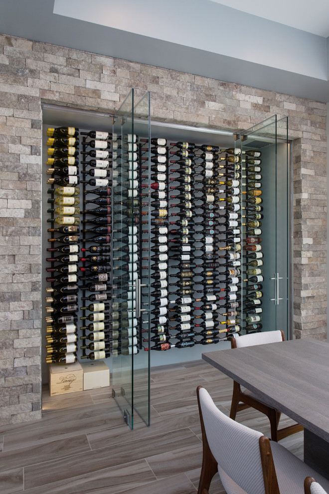Photo of a small contemporary wine cellar in Los Angeles with medium hardwood floors and display racks.