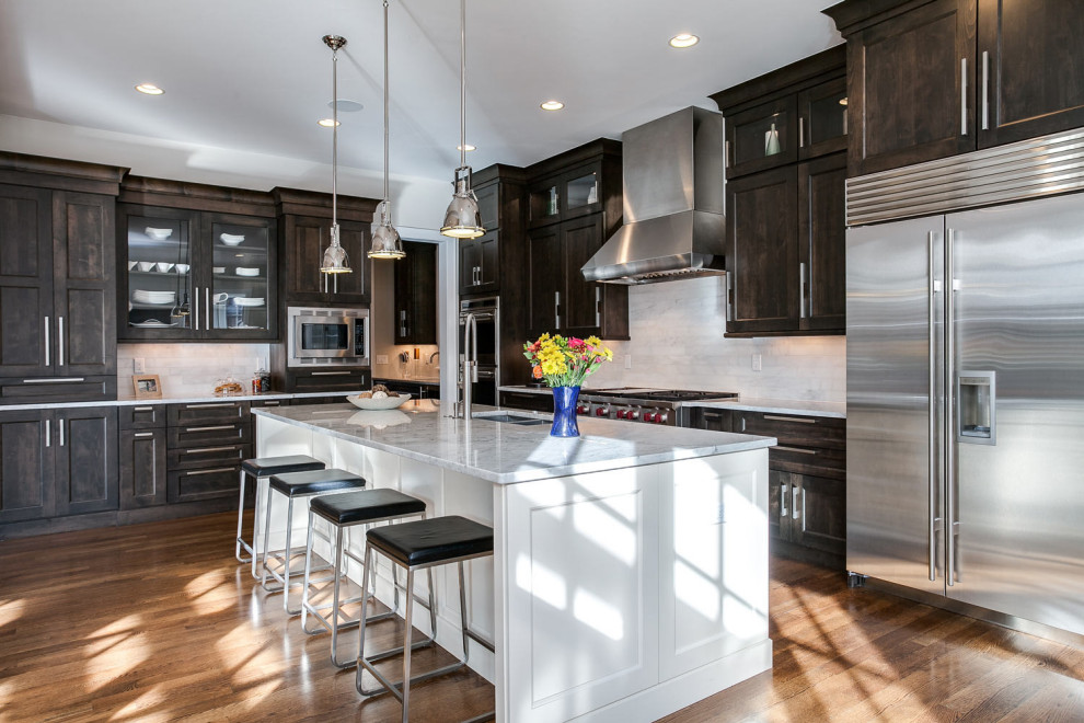 Example of a mid-sized transitional eat-in kitchen design in Miami with an undermount sink and stainless steel appliances
