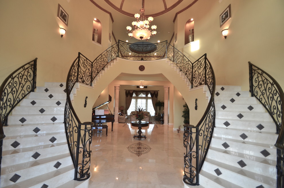 Design ideas for a large traditional curved staircase in Austin with metal railing.