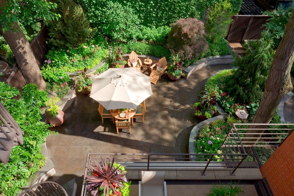 Inspiration for a small traditional courtyard patio in Chicago with natural stone pavers and no cover.