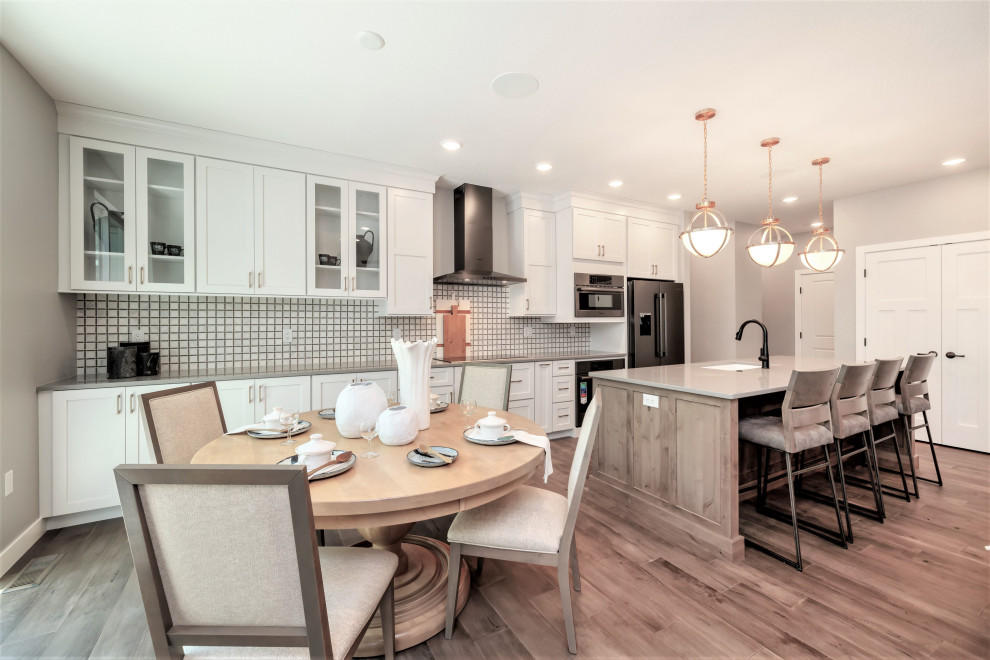 Transitional medium tone wood floor and brown floor kitchen photo in Cedar Rapids