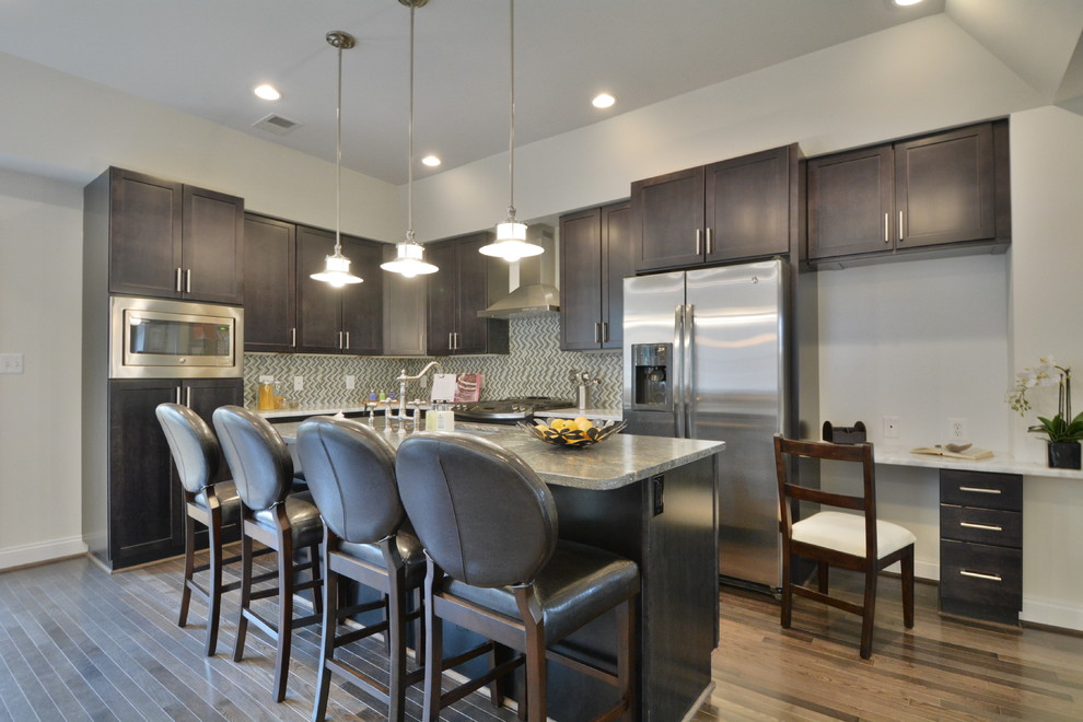 Inspiration for a mid-sized transitional l-shaped medium tone wood floor and brown floor open concept kitchen remodel in DC Metro with an undermount sink, shaker cabinets, dark wood cabinets, granite countertops, glass tile backsplash, stainless steel appliances and an island