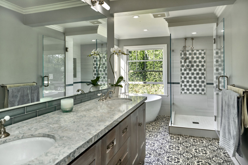 This is an example of a large transitional master bathroom in San Francisco with shaker cabinets, grey cabinets, a freestanding tub, an open shower, a two-piece toilet, white tile, porcelain tile, grey walls, cement tiles, an undermount sink, engineered quartz benchtops, grey floor, an open shower, green benchtops, a double vanity and a built-in vanity.