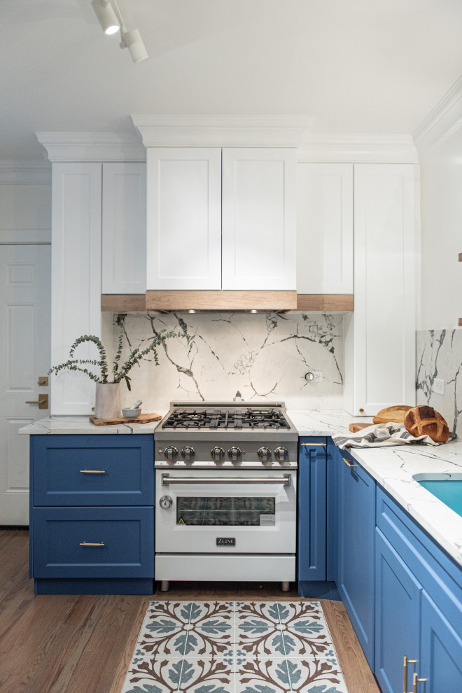 This is an example of a mid-sized transitional l-shaped separate kitchen in Chicago with an undermount sink, flat-panel cabinets, blue cabinets, quartz benchtops, yellow splashback, stone slab splashback, coloured appliances, ceramic floors, no island, blue floor and white benchtop.