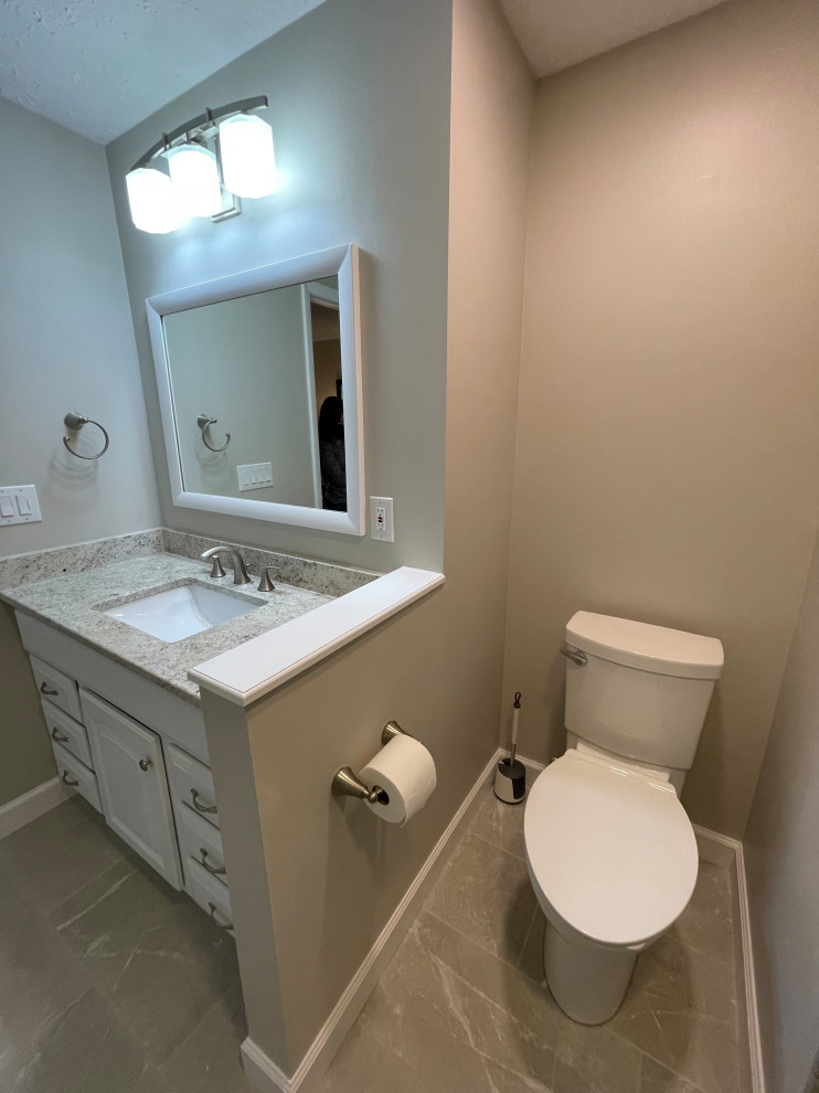 Medium sized classic ensuite bathroom in Cleveland with white cabinets, an alcove shower, a two-piece toilet, white tiles, porcelain tiles, grey walls, porcelain flooring, a submerged sink, engineered stone worktops, white floors, a hinged door, beige worktops, a wall niche, a single sink and a built in vanity unit.