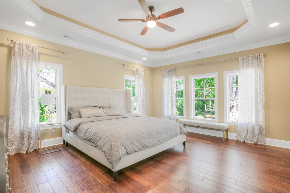 Large arts and crafts master bedroom in Other with beige walls, medium hardwood floors and no fireplace.