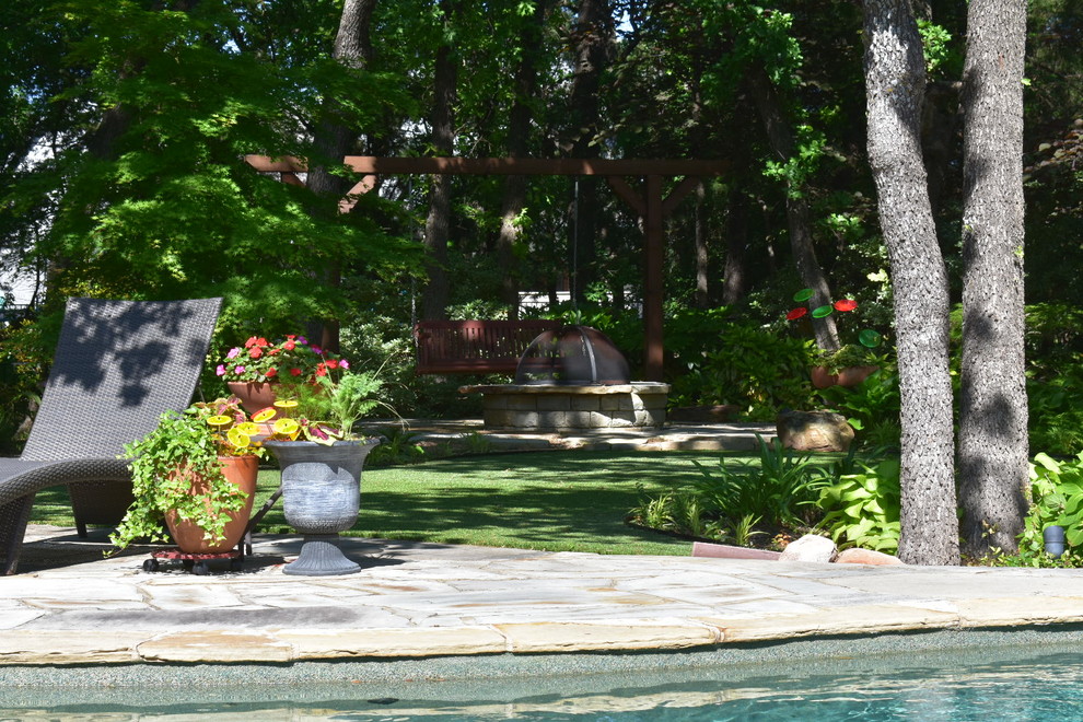 Design ideas for a mid-sized country backyard shaded garden in Dallas with a fire feature.