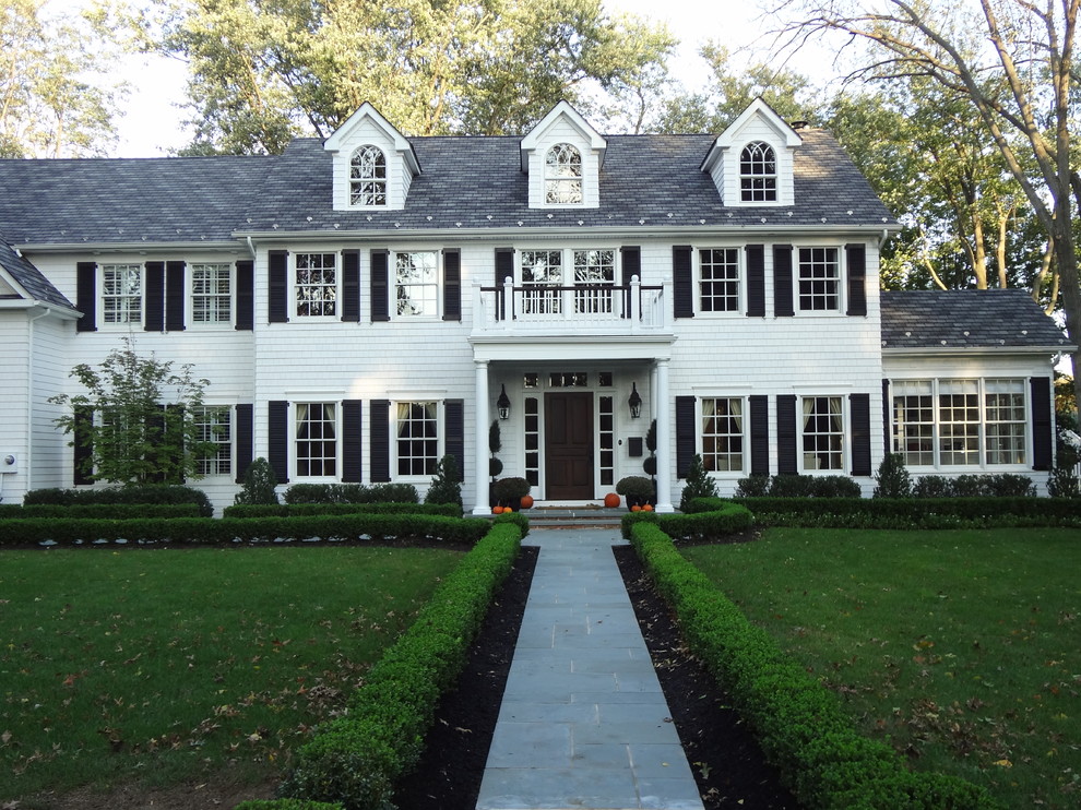This is an example of a large traditional two-storey white exterior in New York with wood siding and a gable roof.