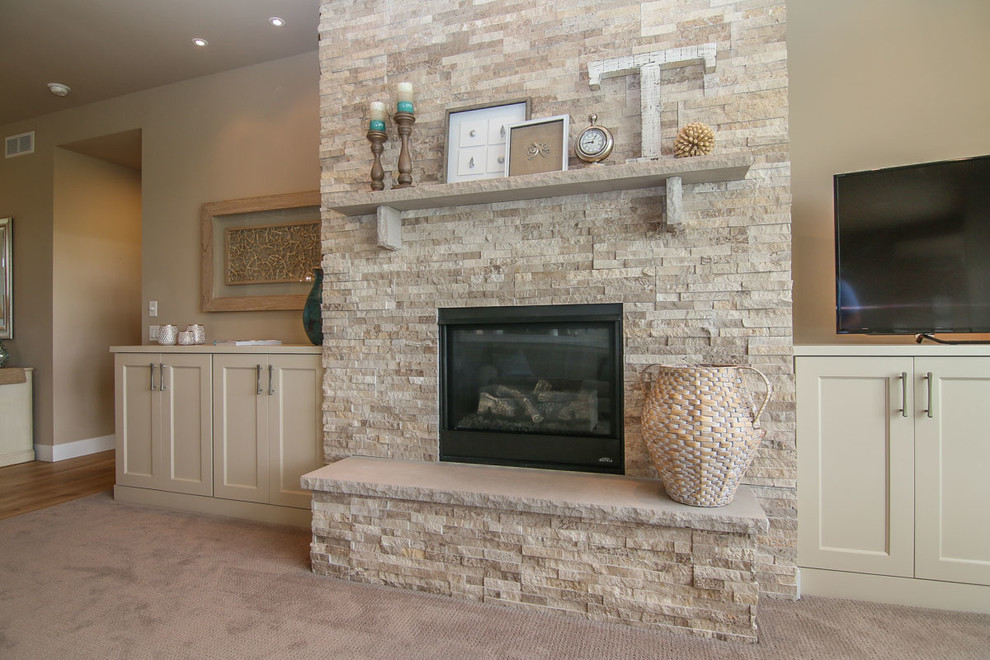 Large beach style living room in Other with beige walls, carpet, a standard fireplace, a stone fireplace surround and a freestanding tv.