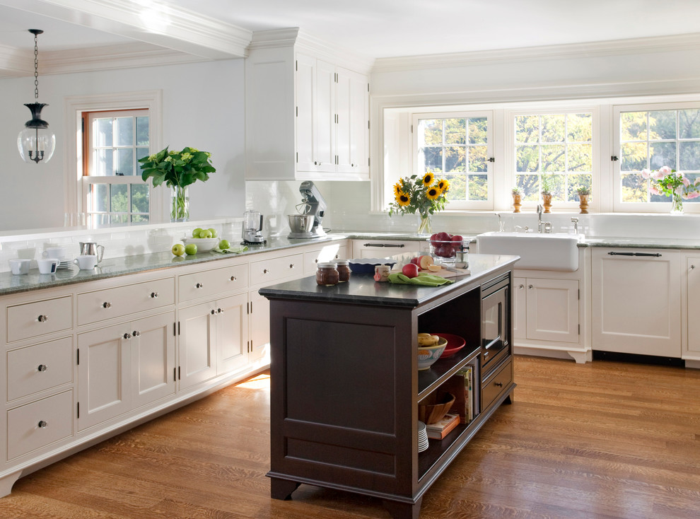 Transitional light wood floor kitchen photo in Boston with a farmhouse sink and recessed-panel cabinets
