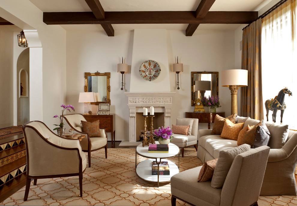 Large mediterranean formal enclosed living room in Santa Barbara with beige walls, a standard fireplace, no tv, dark hardwood floors, a plaster fireplace surround and brown floor.