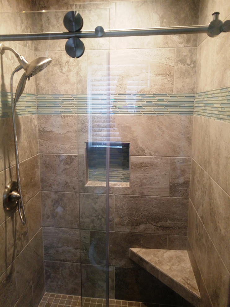 Photo of a mid-sized transitional master bathroom in Other with an alcove shower, a two-piece toilet, beige tile, porcelain tile, porcelain floors, an undermount sink, brown floor, a sliding shower screen and a single vanity.