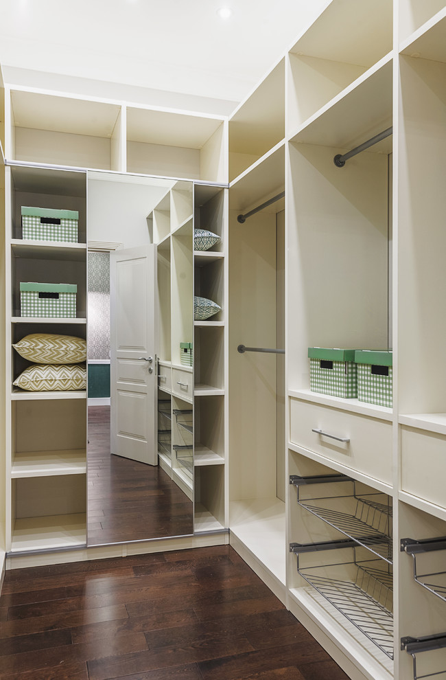 Design ideas for a contemporary gender-neutral walk-in wardrobe in Moscow with open cabinets, white cabinets and dark hardwood floors.