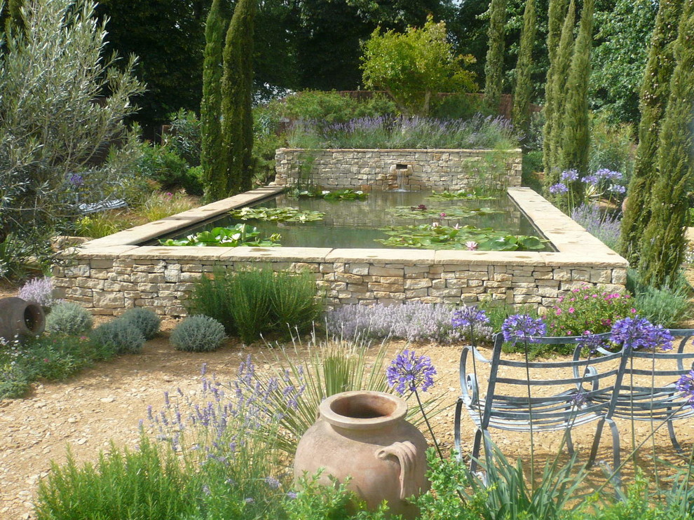 Inspiration for a mediterranean garden in Other with a water feature.