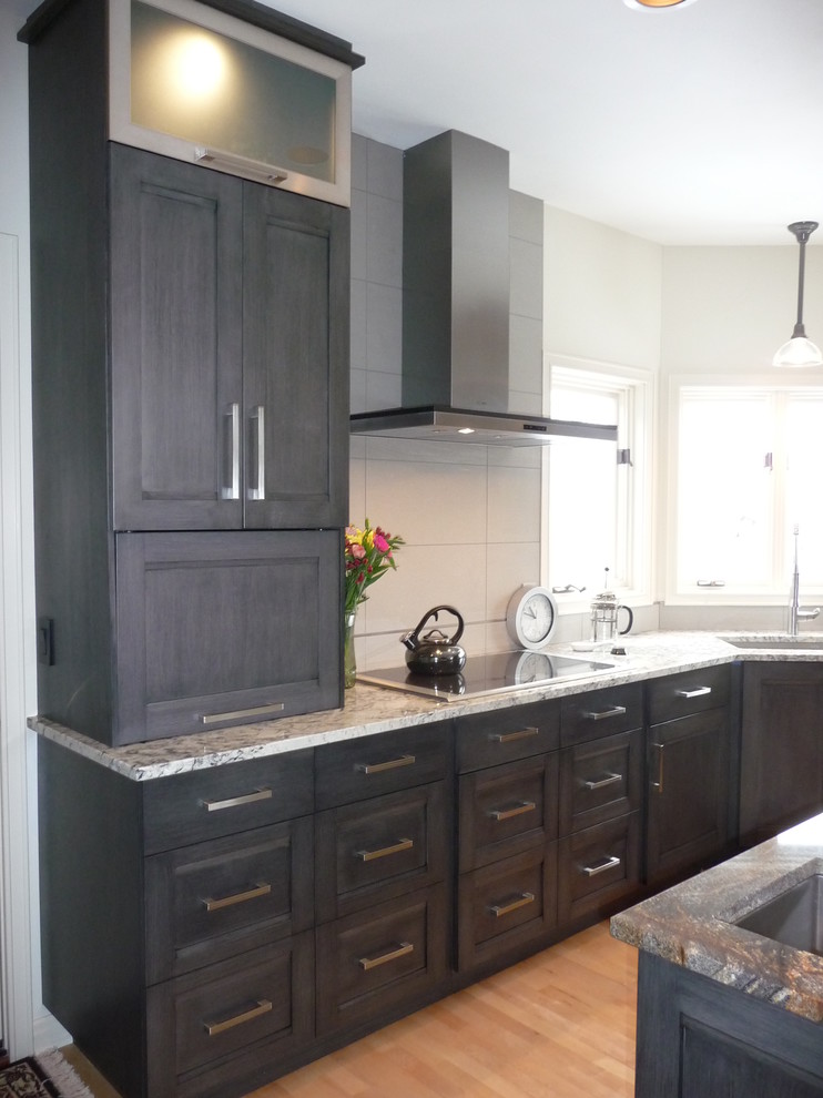 Example of a large transitional u-shaped light wood floor eat-in kitchen design in Milwaukee with an undermount sink, flat-panel cabinets, gray cabinets, granite countertops, white backsplash, porcelain backsplash, stainless steel appliances and an island
