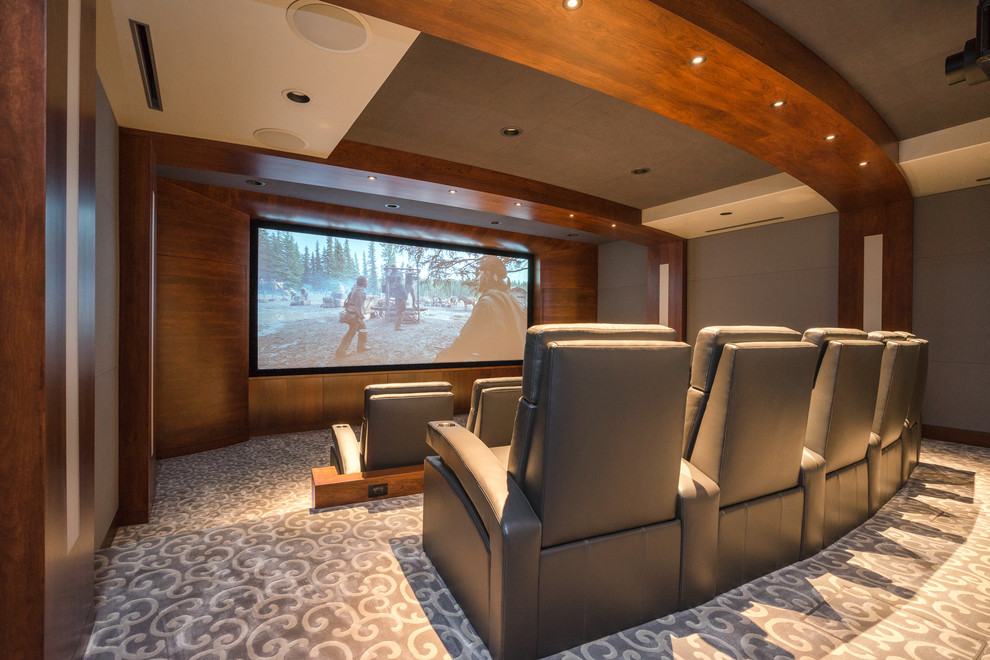 Large contemporary enclosed home theatre in Other with grey walls, carpet, a projector screen and grey floor.