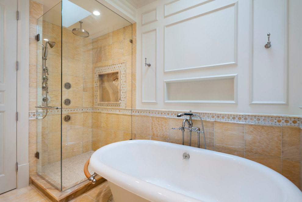 Inspiration for a traditional master bathroom in Vancouver with a drop-in sink, raised-panel cabinets, distressed cabinets, onyx benchtops, a claw-foot tub, a corner shower, a two-piece toilet, yellow tile, stone tile, white walls and marble floors.