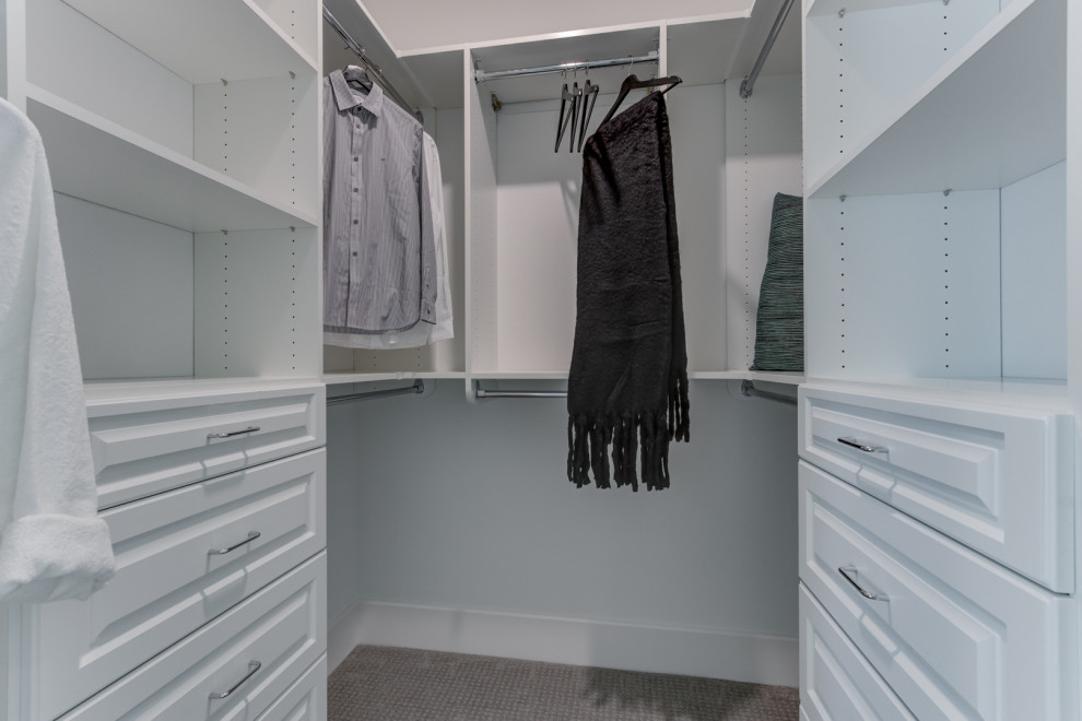 Inspiration for a walk-in wardrobe in San Francisco with raised-panel cabinets, white cabinets, carpet and beige floor.