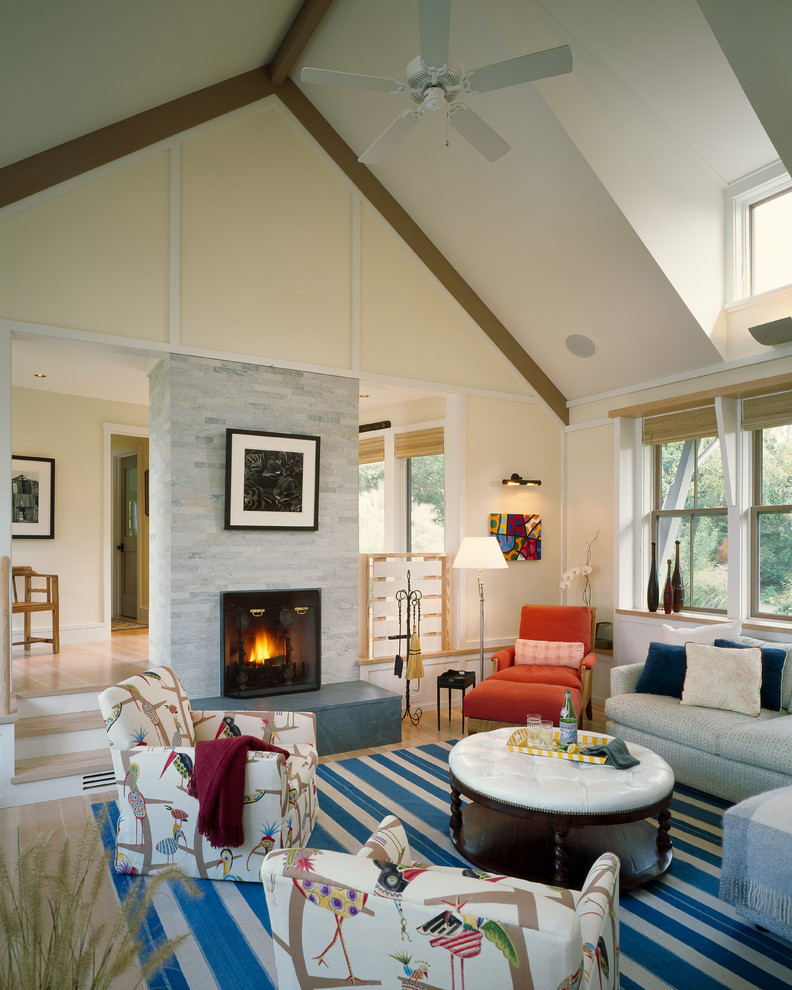 Inspiration for a beach style living room in Boston with beige walls and a standard fireplace.