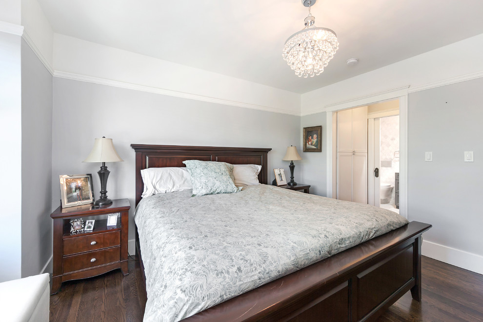 This is an example of a mid-sized transitional master bedroom in San Francisco with grey walls, medium hardwood floors, no fireplace and brown floor.