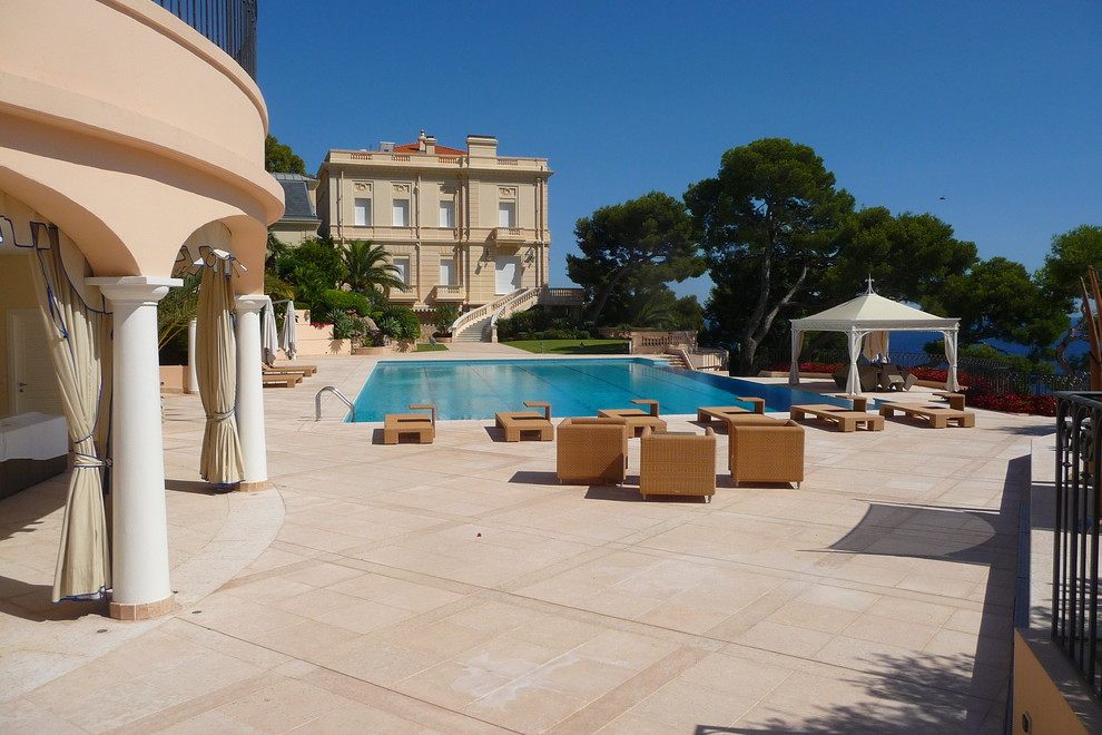 This is an example of a large mediterranean backyard rectangular pool in Nice.