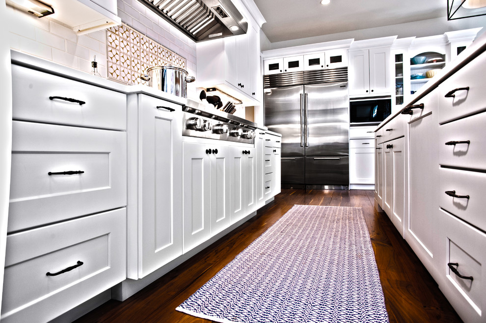 Example of a transitional kitchen design in Denver with flat-panel cabinets and white cabinets