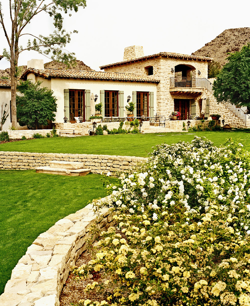 Inspiration for a mediterranean two-storey exterior in Phoenix.