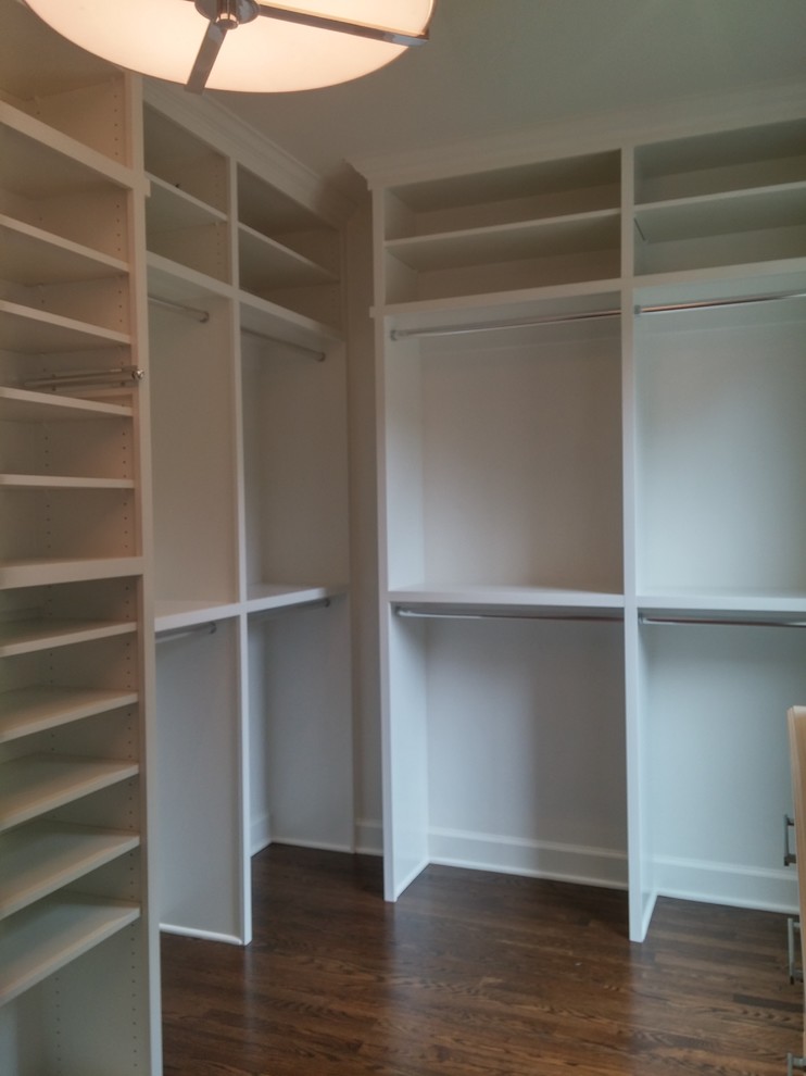 Photo of a large transitional gender-neutral walk-in wardrobe in Nashville with open cabinets, white cabinets and dark hardwood floors.