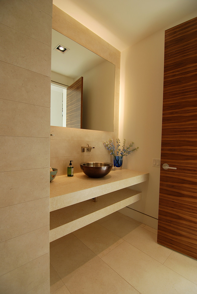 Photo of a modern powder room in Austin with limestone.