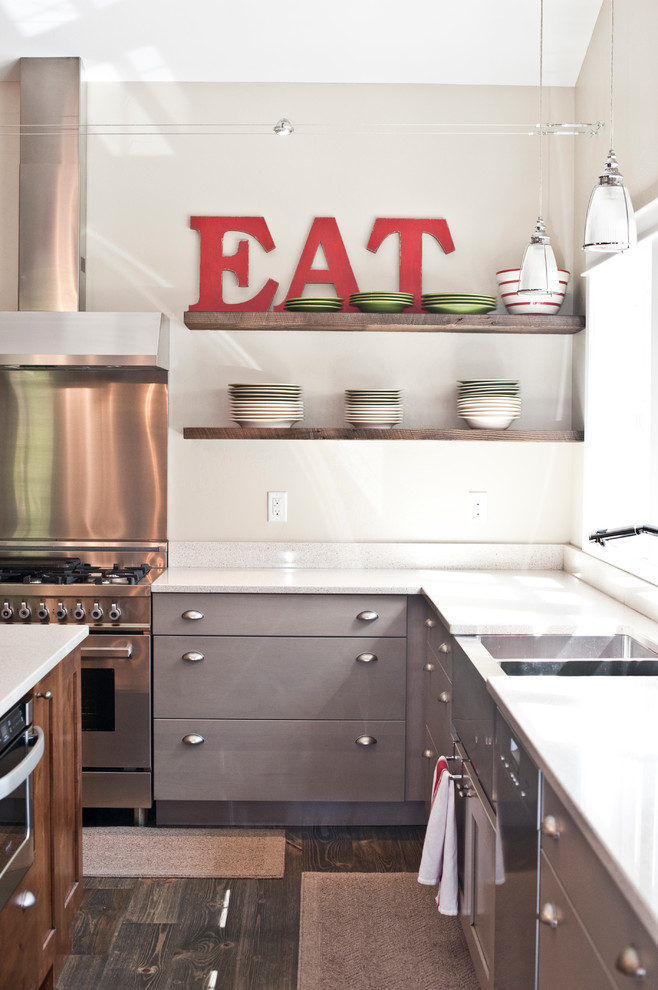 Inspiration for a large transitional l-shaped dark wood floor open concept kitchen remodel with a farmhouse sink, flat-panel cabinets, gray cabinets, quartz countertops, white backsplash, stone slab backsplash, stainless steel appliances and an island