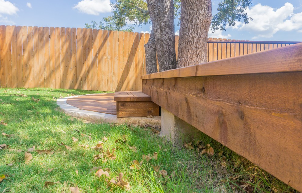 Inspiration for a mid-sized transitional backyard home design remodel in Austin with a roof extension