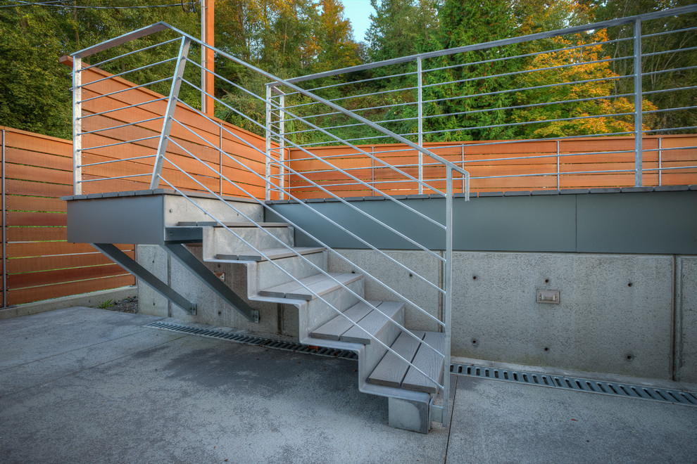 Small modern metal straight staircase in Seattle with metal risers and metal railing.