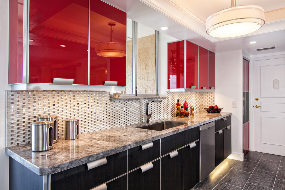 Design ideas for a mid-sized modern galley kitchen in Miami with an undermount sink, glass-front cabinets, red cabinets, granite benchtops, white splashback, glass tile splashback, stainless steel appliances, porcelain floors and no island.