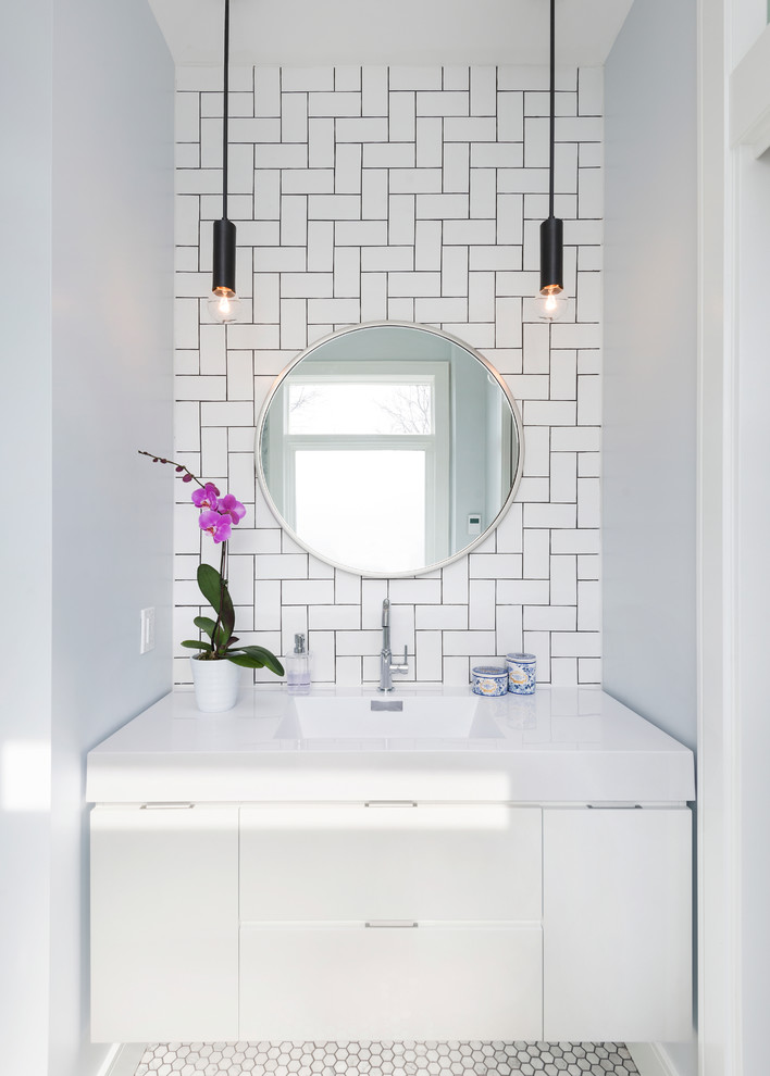 Small contemporary master bathroom in Toronto with flat-panel cabinets, white cabinets, white tile, subway tile, white walls, marble floors, an integrated sink and solid surface benchtops.