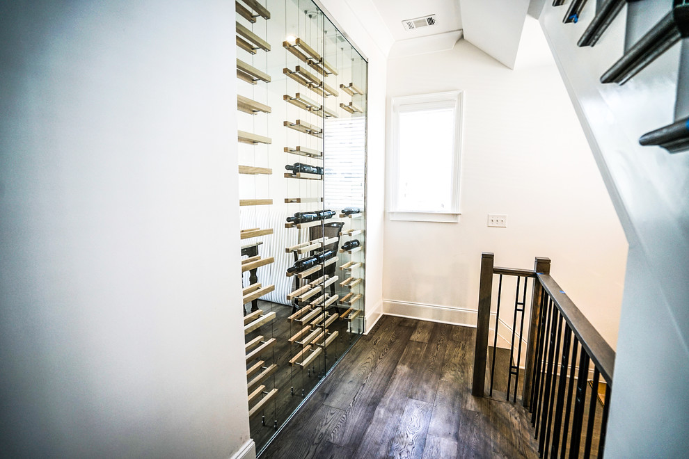 Design ideas for a contemporary wine cellar in Atlanta with dark hardwood floors, storage racks and brown floor.