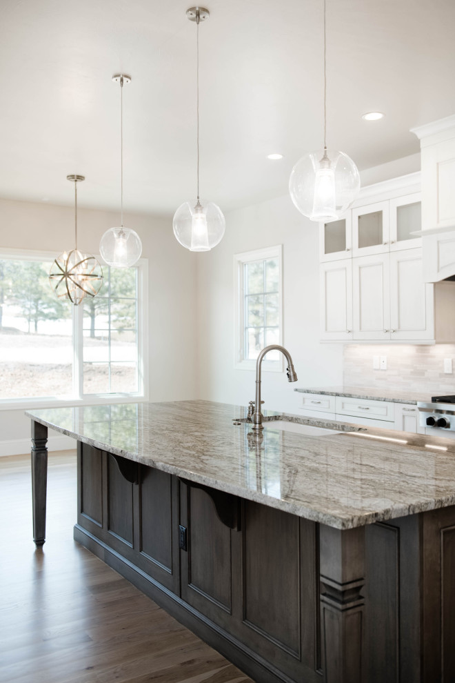 Example of a large transitional l-shaped light wood floor and brown floor eat-in kitchen design in Denver with an undermount sink, flat-panel cabinets, gray cabinets, granite countertops, beige backsplash, stainless steel appliances, an island and gray countertops