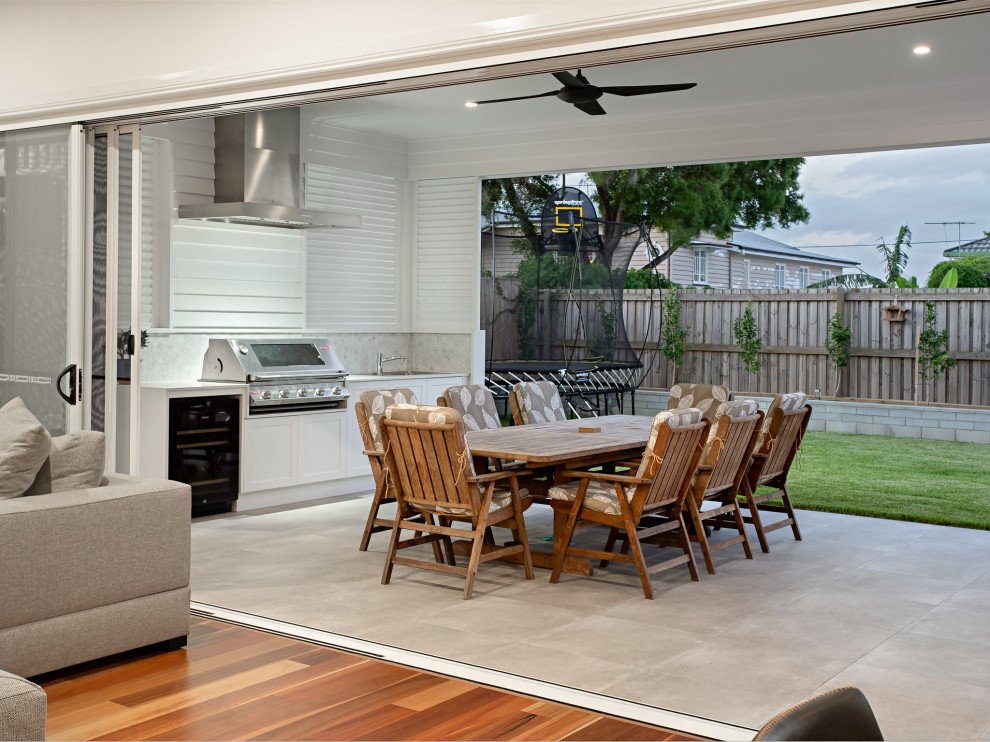 Photo of a mid-sized traditional backyard patio in Brisbane with an outdoor kitchen and a pergola.